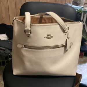 White colored coach bag